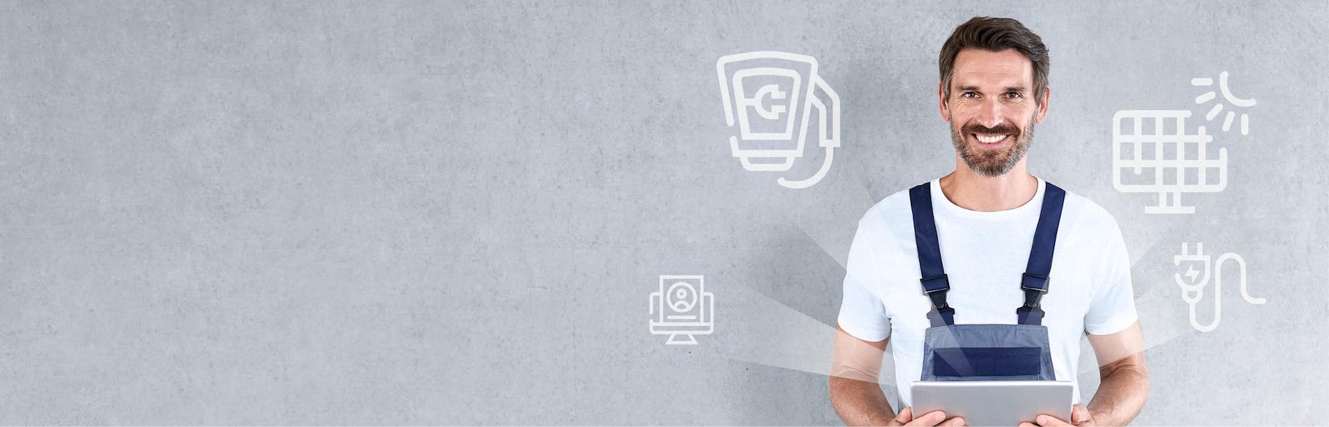 Lächelnder Handwerker mit Tablet in den Händen, Icons zu Strom & Solar.